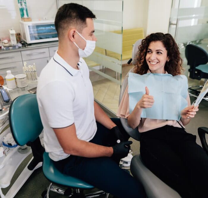 smiling-woman-approving-dental-work (1)